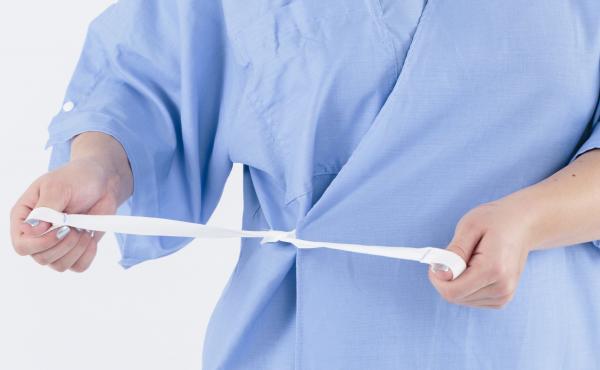 The new hospital garment ties in the front, like a robe, allowing the patient more modesty than the standard gown. The new hospital garment ties in the front, like a robe, allowing the patient more modesty than the standard gown.