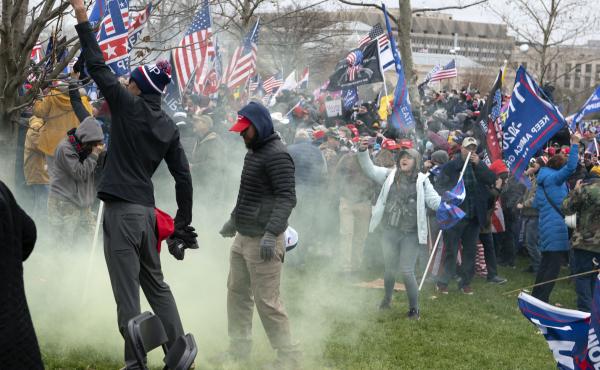 Supporters of former President Donald Trump protest as U.S. Capitol Police officers shoot tear gas during the assault on the Capitol Jan. 6. Supporters of former President Donald Trump protest as U.S. Capitol Police officers shoot tear gas during the assault on the Capitol Jan. 6.