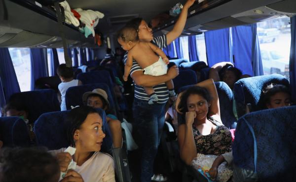 Central American asylum-seekers ride a bus to Tijuana on Wednesday, while passing through San Luis Rio Colorado along the U.S.-Mexico border. Hundreds of immigrants, the remnants of a caravan of Central Americans that began almost a month ago, set out on Central American asylum-seekers ride a bus to Tijuana on Wednesday, while passing through San Luis Rio Colorado along the U.S.-Mexico border. Hundreds of immigrants, the remnants of a caravan of Central Americans that began almost a month ago, set out on