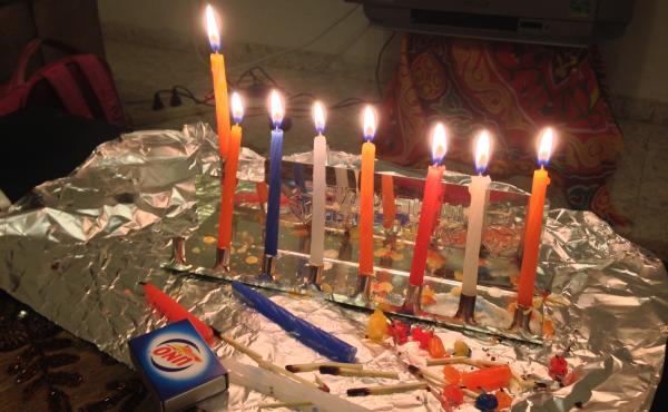 Wolf celebrated Hanukkah in the Palestinian city of Ramallah in the West Bank last year. As the holiday approached, she felt lonely, until her Palestinian host mother and a few neighbors came to watch her light candles on her portable tin menorah and hear Wolf celebrated Hanukkah in the Palestinian city of Ramallah in the West Bank last year. As the holiday approached, she felt lonely, until her Palestinian host mother and a few neighbors came to watch her light candles on her portable tin menorah and hear