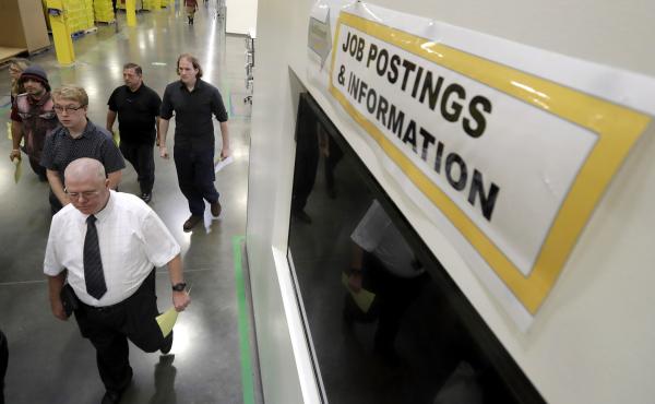 Job candidates take a tour of the Amazon fulfillment center in Robbinsville, N.J., during a job fair last month. The Census Bureau says increased employment is what's driving higher income numbers. Job candidates take a tour of the Amazon fulfillment center in Robbinsville, N.J., during a job fair last month. The Census Bureau says increased employment is what's driving higher income numbers.