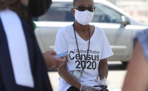 U.S. Census Bureau worker Jennifer Pope wears a face covering at a walk-up counting site in Greenville, Texas, on July 31. The bureau is ending all counting efforts for the 2020 census on Sept. 30, a month shorter than previously announced, the bureau's d U.S. Census Bureau worker Jennifer Pope wears a face covering at a walk-up counting site in Greenville, Texas, on July 31. The bureau is ending all counting efforts for the 2020 census on Sept. 30, a month shorter than previously announced, the bureau's d