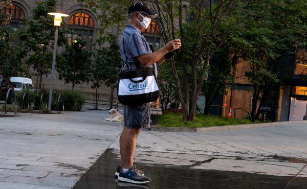 A Census Bureau worker with a face covering stands in a park in New York City in August. The bureau confirmed on Tuesday that door knocking is ending in some areas earlier than Sept. 30. A Census Bureau worker with a face covering stands in a park in New York City in August. The bureau confirmed on Tuesday that door knocking is ending in some areas earlier than Sept. 30.