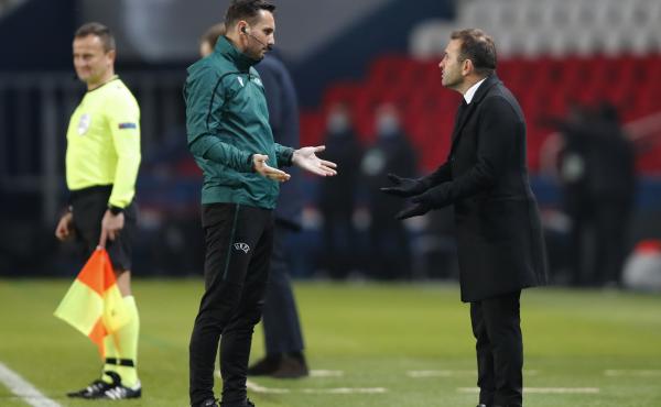 Basaksehir team manager Okan Buruk (right) argues with referee Sebastian Coltescu during a Champions League soccer match between Paris Saint Germain and Istanbul Basaksehir in Paris on Tuesday. Basaksehir team manager Okan Buruk (right) argues with referee Sebastian Coltescu during a Champions League soccer match between Paris Saint Germain and Istanbul Basaksehir in Paris on Tuesday.