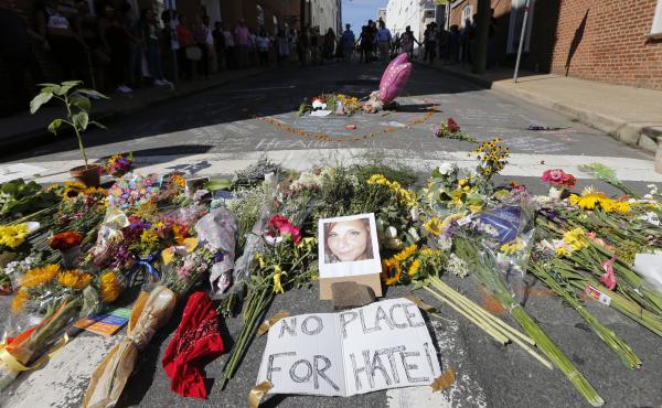 A makeshift memorial of flowers and a photo of victim Heather Heyer sits in Charlottesville, Va., on Aug. 13, 2017. Heyer died when a car rammed into a group of people who were protesting white supremacists who had gathered in the city for a rally. A makeshift memorial of flowers and a photo of victim Heather Heyer sits in Charlottesville, Va., on Aug. 13, 2017. Heyer died when a car rammed into a group of people who were protesting white supremacists who had gathered in the city for a rally.