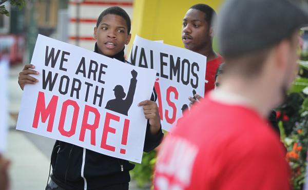 A new minimum wage was approved Tuesday in Chicago, where fast food workers and activists demonstrated outside McDonald's downtown restaurant this summer. A new minimum wage was approved Tuesday in Chicago, where fast food workers and activists demonstrated outside McDonald's downtown restaurant this summer.