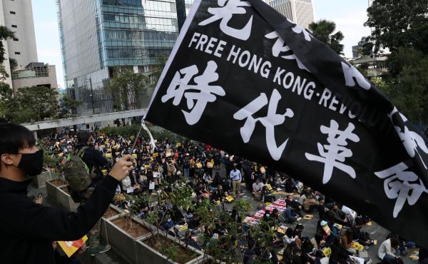 "China urges the U.S. to correct its mistake and stop meddling in Hong Kong affairs," a government spokesperson says, as China retaliates for U.S. support of pro-democracy demonstrators. Here, an activist holds a flag at a lunchtime protest Monday at Chat "China urges the U.S. to correct its mistake and stop meddling in Hong Kong affairs," a government spokesperson says, as China retaliates for U.S. support of pro-democracy demonstrators. Here, an activist holds a flag at a lunchtime protest Monday at Chat
