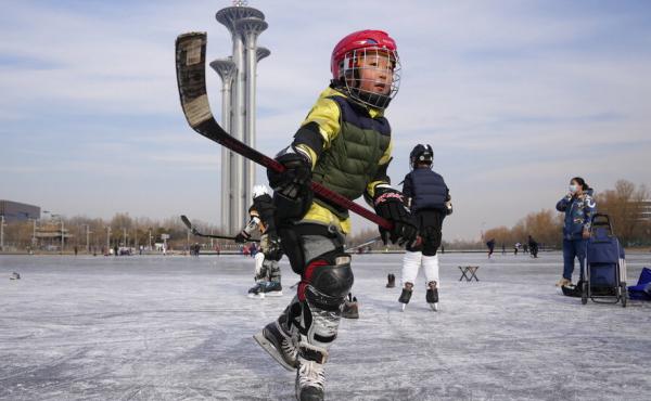 A child practices ice hockey near the Beijing Olympics Tower in Beijing, China, Tuesday, Jan. 18, 2022. A child practices ice hockey near the Beijing Olympics Tower in Beijing, China, Tuesday, Jan. 18, 2022.