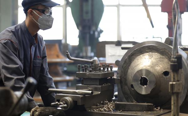 An employee wears a face mask as he works at a blower and fan manufacturing plant in northeastern China's Liaoning province. The economy contracted by 6.8% in the first three months of 2020 from the same period a year ago. An employee wears a face mask as he works at a blower and fan manufacturing plant in northeastern China's Liaoning province. The economy contracted by 6.8% in the first three months of 2020 from the same period a year ago.
