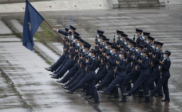 Hong Kong police show their new goose step marching style on National Security Education Day at a police school in Hong Kong on April 15. Hong Kong police show their new goose step marching style on National Security Education Day at a police school in Hong Kong on April 15.