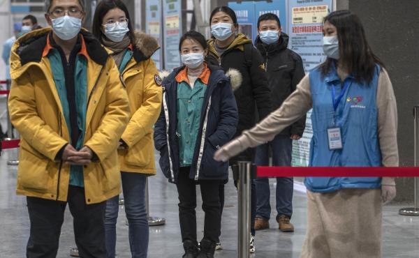 Chinese workers wait to receive a COVID-19 vaccine jab at a mass vaccination center in Beijing on Jan. 5. Even with at least 5 homegrown vaccines nearing approval, China is setting a modest initial goal: 50 million people vaccinated by mid-February — ab Chinese workers wait to receive a COVID-19 vaccine jab at a mass vaccination center in Beijing on Jan. 5. Even with at least 5 homegrown vaccines nearing approval, China is setting a modest initial goal: 50 million people vaccinated by mid-February — ab