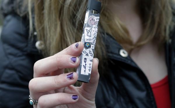A 15-year-old in Cambridge, Mass., shows off her vaping device in 2018. Schools and health officials across the U.S. are struggling to curb what they say is an epidemic of underage vaping. A 15-year-old in Cambridge, Mass., shows off her vaping device in 2018. Schools and health officials across the U.S. are struggling to curb what they say is an epidemic of underage vaping.