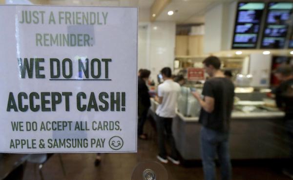 A sign alerts customers that cash is not accepted at a shop in San Francisco last year. The city subsequently banned businesses from rejecting cash. A sign alerts customers that cash is not accepted at a shop in San Francisco last year. The city subsequently banned businesses from rejecting cash.