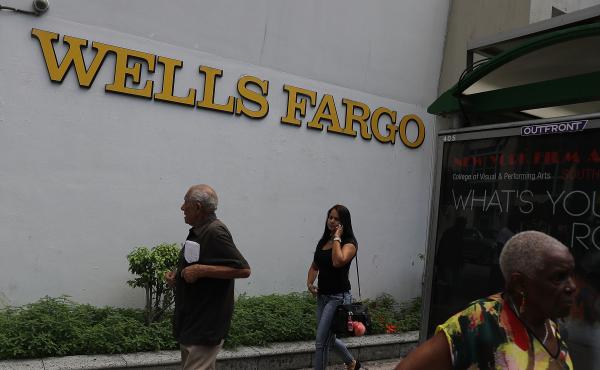 People walk in front of a Wells Fargo branch on Sept. 9, 2016 in Miami, Fla. On Monday, the U.S. Supreme Court ruled that the city of Miami can sue Wells Fargo and Bank of America under the Fair Housing Act for damages caused by allegedly predatory and di People walk in front of a Wells Fargo branch on Sept. 9, 2016 in Miami, Fla. On Monday, the U.S. Supreme Court ruled that the city of Miami can sue Wells Fargo and Bank of America under the Fair Housing Act for damages caused by allegedly predatory and di