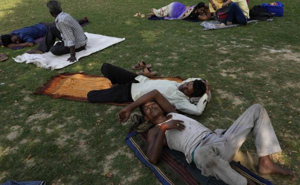 People rest in the shade of a tree on a hot summer afternoon in Lucknow in the central Indian state of Uttar Pradesh, on Thursday. Severe heat wave conditions are sweeping north and western parts of India. People rest in the shade of a tree on a hot summer afternoon in Lucknow in the central Indian state of Uttar Pradesh, on Thursday. Severe heat wave conditions are sweeping north and western parts of India.