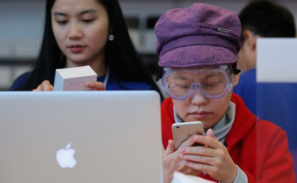A customer sets up her new iPhone 6 at an Apple store in Beijing on Friday. A group says the Chinese government backed an attack against users of Apple's iCloud service, but the government denies the claim. A customer sets up her new iPhone 6 at an Apple store in Beijing on Friday. A group says the Chinese government backed an attack against users of Apple's iCloud service, but the government denies the claim.