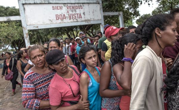 Venezuelans wait in line for food in northern Brazil. The migrants often say the main reasons they've fled are to get food and health care. Venezuelans wait in line for food in northern Brazil. The migrants often say the main reasons they've fled are to get food and health care.