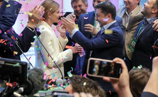 Ukrainian comedian and president-elect Volodymyr Zelenskiy, center right, and his wife Olena Zelenska, center left, greet supporters at his headquarters on Sunday. Ukrainian comedian and president-elect Volodymyr Zelenskiy, center right, and his wife Olena Zelenska, center left, greet supporters at his headquarters on Sunday.