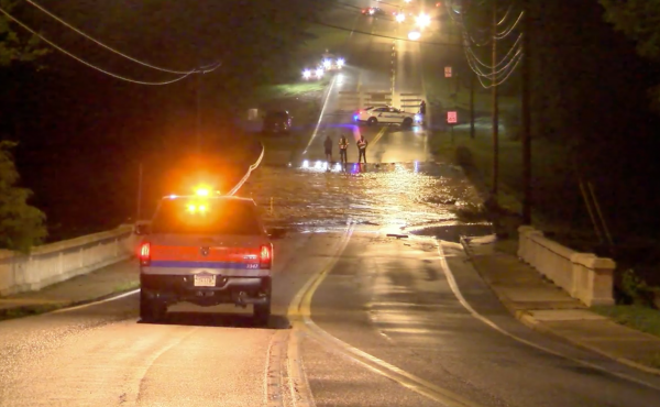 A screenshot from a video posted by the City of Lynchburg shows water flowing over Lakeside Drive, which runs atop the College Lake Dam in the Virginia city. A screenshot from a video posted by the City of Lynchburg shows water flowing over Lakeside Drive, which runs atop the College Lake Dam in the Virginia city.