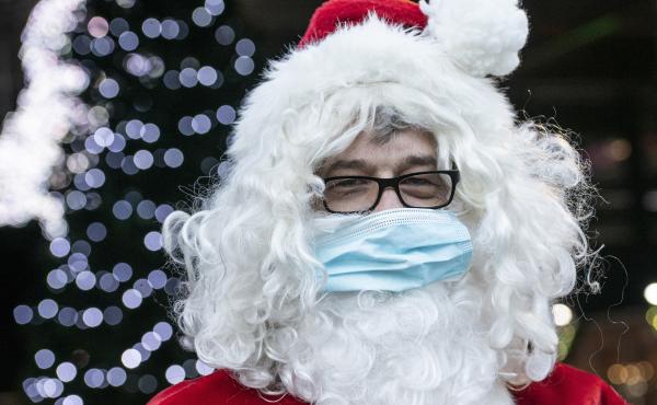 A Santa Claus in Germany wears a surgical mask in December 2020. If you're planning to take the kids to see Santa this year, experts say it's safest to keep everyone's masks on. A Santa Claus in Germany wears a surgical mask in December 2020. If you're planning to take the kids to see Santa this year, experts say it's safest to keep everyone's masks on.
