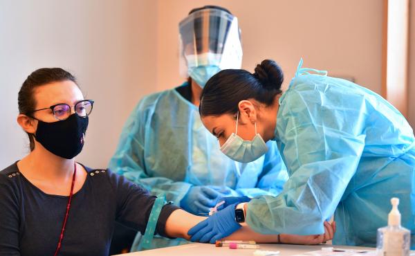 A phlebotomist draws blood at a free COVID-19 antibody testing event on Feb.17 in Pico Rivera, Calif. A phlebotomist draws blood at a free COVID-19 antibody testing event on Feb.17 in Pico Rivera, Calif.