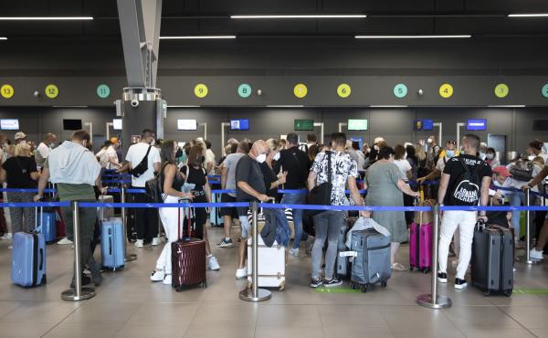 Passengers queue up at Greece's Thessaloniki Makedonia Airport on Sept. 2. Recommendations about physical distancing prove hard to follow at airports — and in the jetway leading to the plane. Passengers queue up at Greece's Thessaloniki Makedonia Airport on Sept. 2. Recommendations about physical distancing prove hard to follow at airports — and in the jetway leading to the plane.