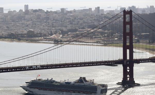 The Grand Princess cruise ship heads under the Golden Gate Bridge to a port in Oakland, Calif., on Monday. The ship's more than 2,400 passengers are headed to either medical care or a quarantine due to the coronavirus. The Grand Princess cruise ship heads under the Golden Gate Bridge to a port in Oakland, Calif., on Monday. The ship's more than 2,400 passengers are headed to either medical care or a quarantine due to the coronavirus.