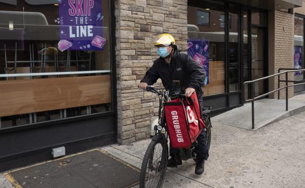 In this April 21, 2021, file photo, a delivery man bikes with a food bag from Grubhub in New York. The three biggest food delivery companies, DoorDash, Grubhub and Uber Eats, sued the City of New York in 2021 over its law to permanently limit the amount t In this April 21, 2021, file photo, a delivery man bikes with a food bag from Grubhub in New York. The three biggest food delivery companies, DoorDash, Grubhub and Uber Eats, sued the City of New York in 2021 over its law to permanently limit the amount t