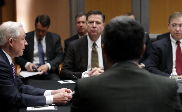 U.S. Attorney General Jeff Sessions (left) speaks with former FBI Director James Comey (center) and other officials at the Department of Justice in April 2017, in Washington. U.S. Attorney General Jeff Sessions (left) speaks with former FBI Director James Comey (center) and other officials at the Department of Justice in April 2017, in Washington.