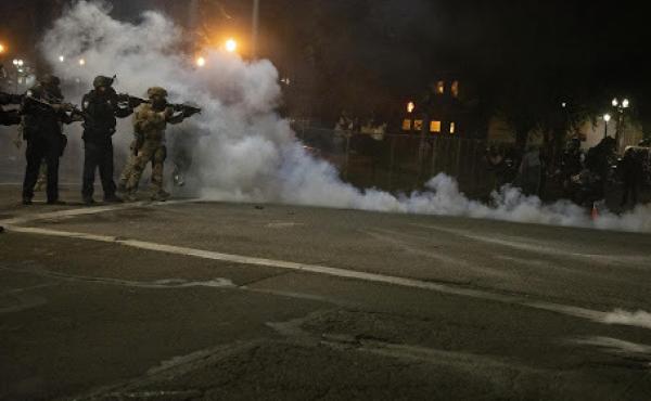 Federal law enforcement officers fire impact munitions and tear gas at protesters demonstrating against racism and police violence in front of the Mark O. Hatfield federal courthouse in Portland, Ore., on July 16, 2020. Through the end of 2020, the majori Federal law enforcement officers fire impact munitions and tear gas at protesters demonstrating against racism and police violence in front of the Mark O. Hatfield federal courthouse in Portland, Ore., on July 16, 2020. Through the end of 2020, the majori