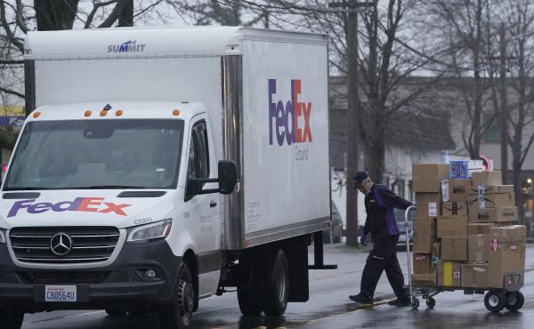 A driver with FedEx carries a package away from a van in Seattle. A huge increase in online shopping this year has demand for package delivery exceeding capacity this holiday season and stretching the delivery supply chain thin. A driver with FedEx carries a package away from a van in Seattle. A huge increase in online shopping this year has demand for package delivery exceeding capacity this holiday season and stretching the delivery supply chain thin.