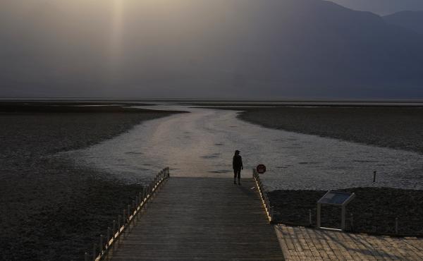A person walks on a boardwalk at the salt flats at Badwater Basin on Aug. 17, 2020, in Death Valley National Park in California. Temperatures reached 130 degrees there on Friday. A person walks on a boardwalk at the salt flats at Badwater Basin on Aug. 17, 2020, in Death Valley National Park in California. Temperatures reached 130 degrees there on Friday.