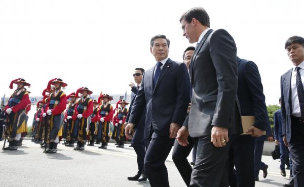 U.S. Defense Secretary Mark Esper (front right), flanked by South Korean Defense Minister Jeong Kyeong-doo (center), arrives at the Defense Ministry in Seoul, South Korea, on Friday. U.S. Defense Secretary Mark Esper (front right), flanked by South Korean Defense Minister Jeong Kyeong-doo (center), arrives at the Defense Ministry in Seoul, South Korea, on Friday.