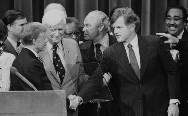 Months after his challenge to the incumbent President Carter had failed, Sen. Edward Kennedy (D-Mass.) makes a belated gesture of unity in the closing moments of the 1980 National Convention. Months after his challenge to the incumbent President Carter had failed, Sen. Edward Kennedy (D-Mass.) makes a belated gesture of unity in the closing moments of the 1980 National Convention.