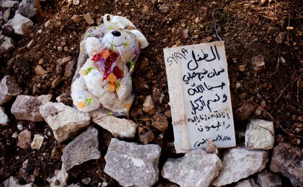 At a makeshift burial ground in Samos, beyond the edges of a Greek Orthodox cemetery, lie the bodies of three Syrian children. The marker reads, "The child Noaman Tamim Shibly — For us Allah suffices, and he is the best disposer of affairs. To God we be At a makeshift burial ground in Samos, beyond the edges of a Greek Orthodox cemetery, lie the bodies of three Syrian children. The marker reads, "The child Noaman Tamim Shibly — For us Allah suffices, and he is the best disposer of affairs. To God we be