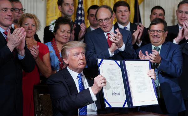 President Trump holds up the signed Department of Veterans Affairs Accountability and Whistleblower Protection Act of 2017 on Friday. President Trump holds up the signed Department of Veterans Affairs Accountability and Whistleblower Protection Act of 2017 on Friday.