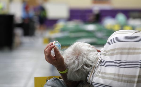 An evacuee lies on a cot at an evacuation shelter for people with disabilities in Stuart, Fla., in preparation for Hurricane Dorian on Sept. 1, 2019. Now, with the pandemic raging, officials across the South are trying to adjust their evacuation and shelt An evacuee lies on a cot at an evacuation shelter for people with disabilities in Stuart, Fla., in preparation for Hurricane Dorian on Sept. 1, 2019. Now, with the pandemic raging, officials across the South are trying to adjust their evacuation and shelt