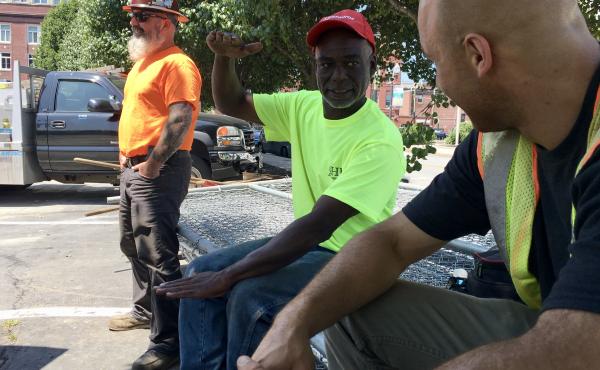 Calvin Brandford (center) is a certified minority contractor who has run an excavation business north of Boston for almost 30 years. Brandford said getting state-funded work as a subcontractor is very hard and often comes with a serious drawback: not gett Calvin Brandford (center) is a certified minority contractor who has run an excavation business north of Boston for almost 30 years. Brandford said getting state-funded work as a subcontractor is very hard and often comes with a serious drawback: not gett