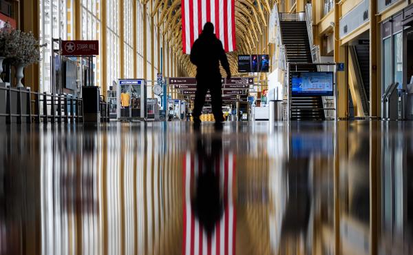 An airport employee walks through Reagan National Airport in Arlington, Va., earlier this year. On Thursday, the Centers for Disease Control and Prevention warned that Americans should refrain from traveling for the upcoming holiday. An airport employee walks through Reagan National Airport in Arlington, Va., earlier this year. On Thursday, the Centers for Disease Control and Prevention warned that Americans should refrain from traveling for the upcoming holiday.