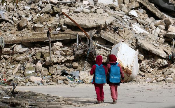 Girls carrying school bags provided by UNICEF walk past destroyed buildings on their way home from school on March 7 in the rebel-held al-Shaar neighborhood of Aleppo, Syria. So many people have fled the city and so much of its infrastructure has been des Girls carrying school bags provided by UNICEF walk past destroyed buildings on their way home from school on March 7 in the rebel-held al-Shaar neighborhood of Aleppo, Syria. So many people have fled the city and so much of its infrastructure has been des