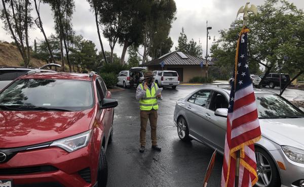 An immigration officer administers the Oath of Allegiance at a drive-through naturalization ceremony in El Cajon, Calif. An immigration officer administers the Oath of Allegiance at a drive-through naturalization ceremony in El Cajon, Calif.