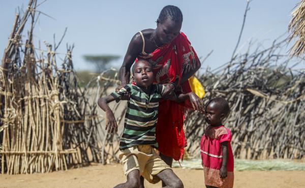 A mother helps her malnourished son stand after he collapsed near their hut in the village of Lomoputh in northern Kenya on Thursday. A severe drought and spiking food prices are causing a humanitarian emergency in the Horn of Africa. A mother helps her malnourished son stand after he collapsed near their hut in the village of Lomoputh in northern Kenya on Thursday. A severe drought and spiking food prices are causing a humanitarian emergency in the Horn of Africa.