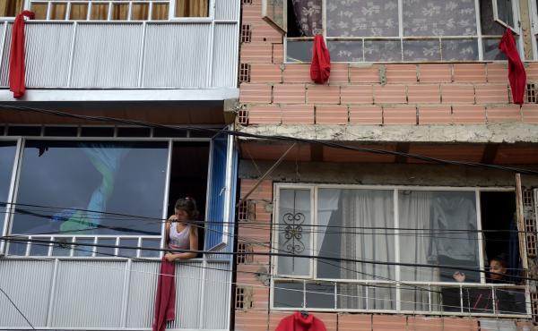 Residents of the Colombian capital Bogotá hang red rags from their windows and balconies to signal their need for help with food during the coronavirus pandemic. Residents of the Colombian capital Bogotá hang red rags from their windows and balconies to signal their need for help with food during the coronavirus pandemic.