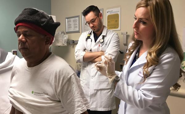 Francisco Hidalgo prepares to receive a trigger point injection from Dr. Alexis LaPietra (right) at St. Joseph's University Medical Center in Paterson, N.J., while Dr. Tyler Manis observes. An alternative to opioids, the trigger point injection involves d Francisco Hidalgo prepares to receive a trigger point injection from Dr. Alexis LaPietra (right) at St. Joseph's University Medical Center in Paterson, N.J., while Dr. Tyler Manis observes. An alternative to opioids, the trigger point injection involves d