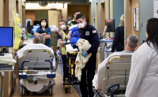 An ambulance crew weaves a gurney through the halls of Sparrow Hospital's emergency department in Lansing, Michigan. Overcrowding has forced the staff to triage patients, putting some in the waiting rooms and treating others on stretchers and chairs in th An ambulance crew weaves a gurney through the halls of Sparrow Hospital's emergency department in Lansing, Michigan. Overcrowding has forced the staff to triage patients, putting some in the waiting rooms and treating others on stretchers and chairs in th