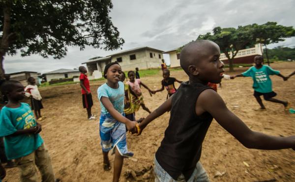 Mariama and Fomba Kanneh play in an open space in Barkedu, Liberia. With schools closed across the country, many kids spend their time playing outside every day. Mariama and Fomba Kanneh play in an open space in Barkedu, Liberia. With schools closed across the country, many kids spend their time playing outside every day.