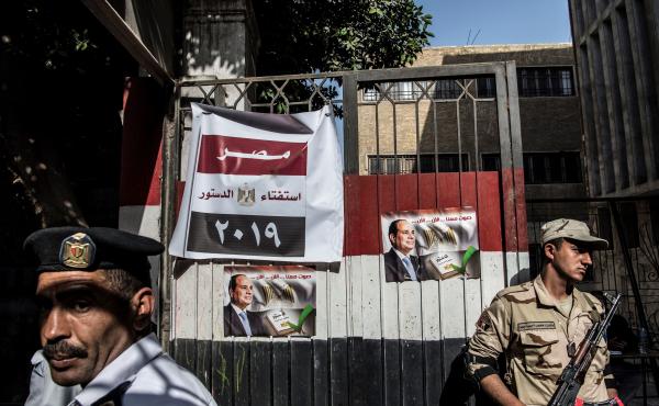 An Egyptian soldier and a policeman stand guard at a Cairo polling station on Monday, the third day of a referendum on constitutional amendments. An Egyptian soldier and a policeman stand guard at a Cairo polling station on Monday, the third day of a referendum on constitutional amendments.