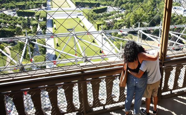A couple take in the view as they visit the Eiffel Tower on Thursday. Paris' iconic tower is reopening after the coronavirus forced the longest closure since World War II. A couple take in the view as they visit the Eiffel Tower on Thursday. Paris' iconic tower is reopening after the coronavirus forced the longest closure since World War II.