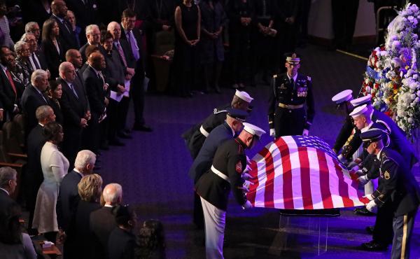A military honor guard lays the U.S. flag on the casket of Rep. Elijah Cummings during his funeral service at New Psalmist Baptist Church in Baltimore on Friday. A military honor guard lays the U.S. flag on the casket of Rep. Elijah Cummings during his funeral service at New Psalmist Baptist Church in Baltimore on Friday.