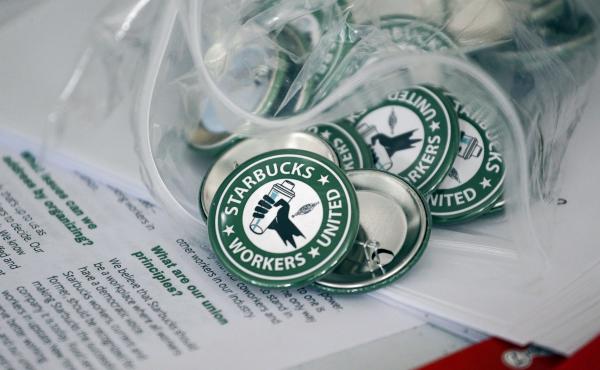Pro-union pins sit on a table during a watch party for Starbucks' employees union election, Dec. 9, 2021, in Buffalo, N.Y. The top lawyer for the National Labor Relations Board said Thursday, April 7, she will ask the board to rule that mandatory meetings Pro-union pins sit on a table during a watch party for Starbucks' employees union election, Dec. 9, 2021, in Buffalo, N.Y. The top lawyer for the National Labor Relations Board said Thursday, April 7, she will ask the board to rule that mandatory meetings
